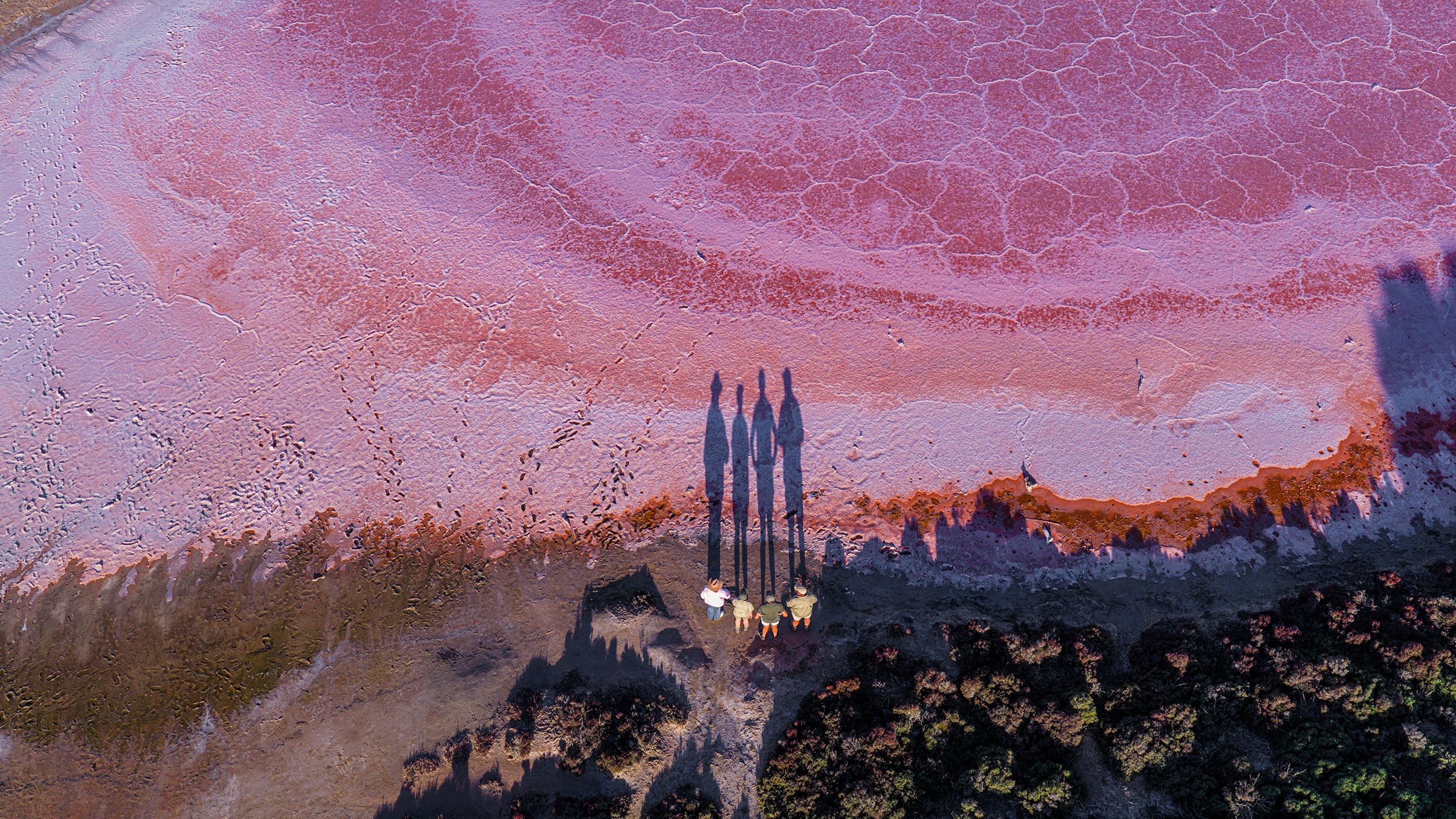 People standing on Pink Lakes at sunset. Photo credit: mildura.com