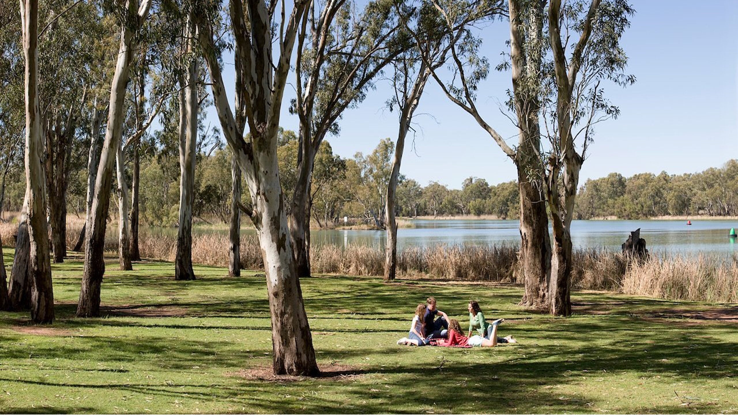 A couple having a picnic by a lake in the picturesque Loddon-Mallee Region