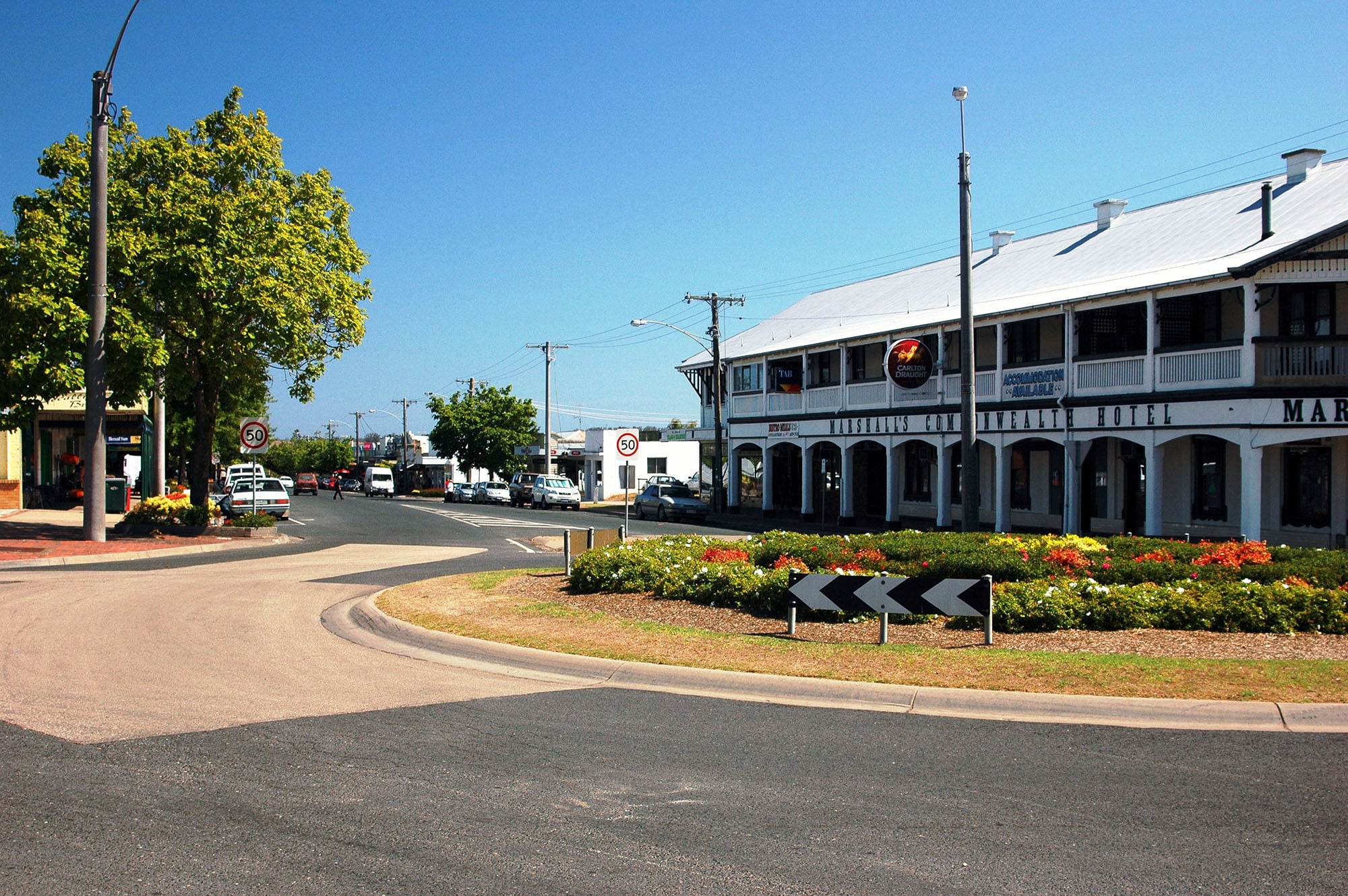 A large, white, two-storey corner building with a sign reading Marshalls Commonwealth Hotel.